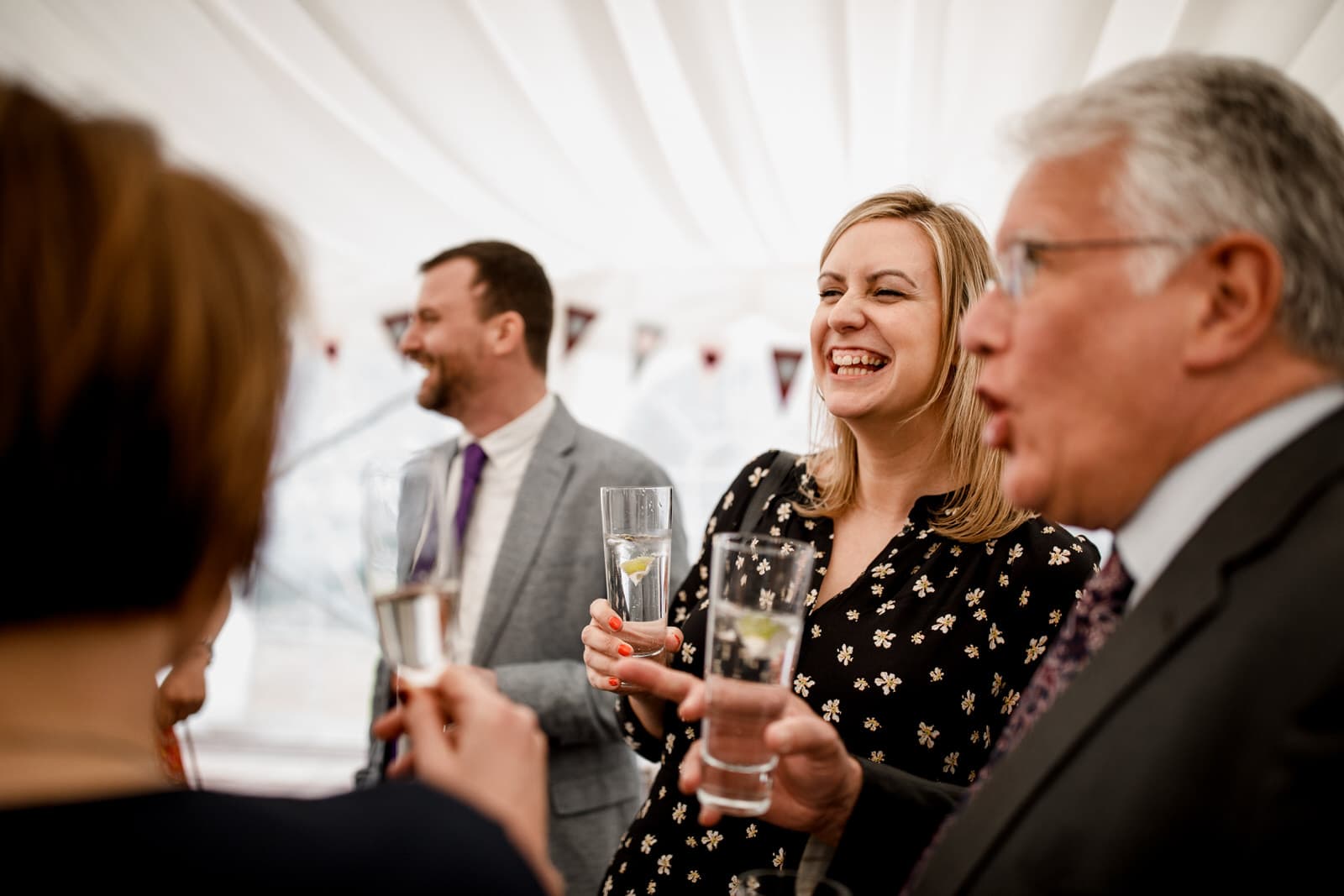 guest laughing at marquee reception
