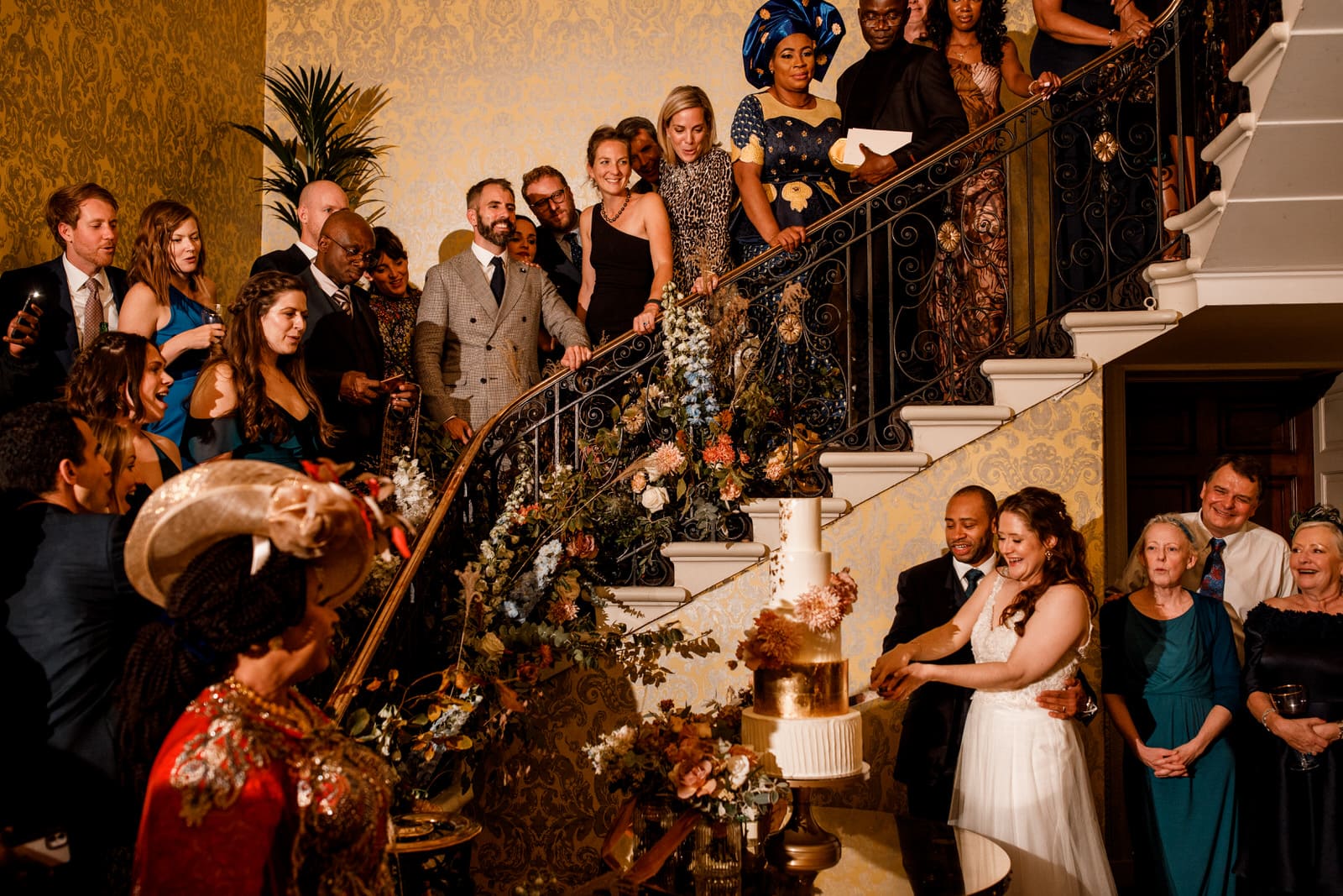 cake cut under stairs at hedsor house wedding