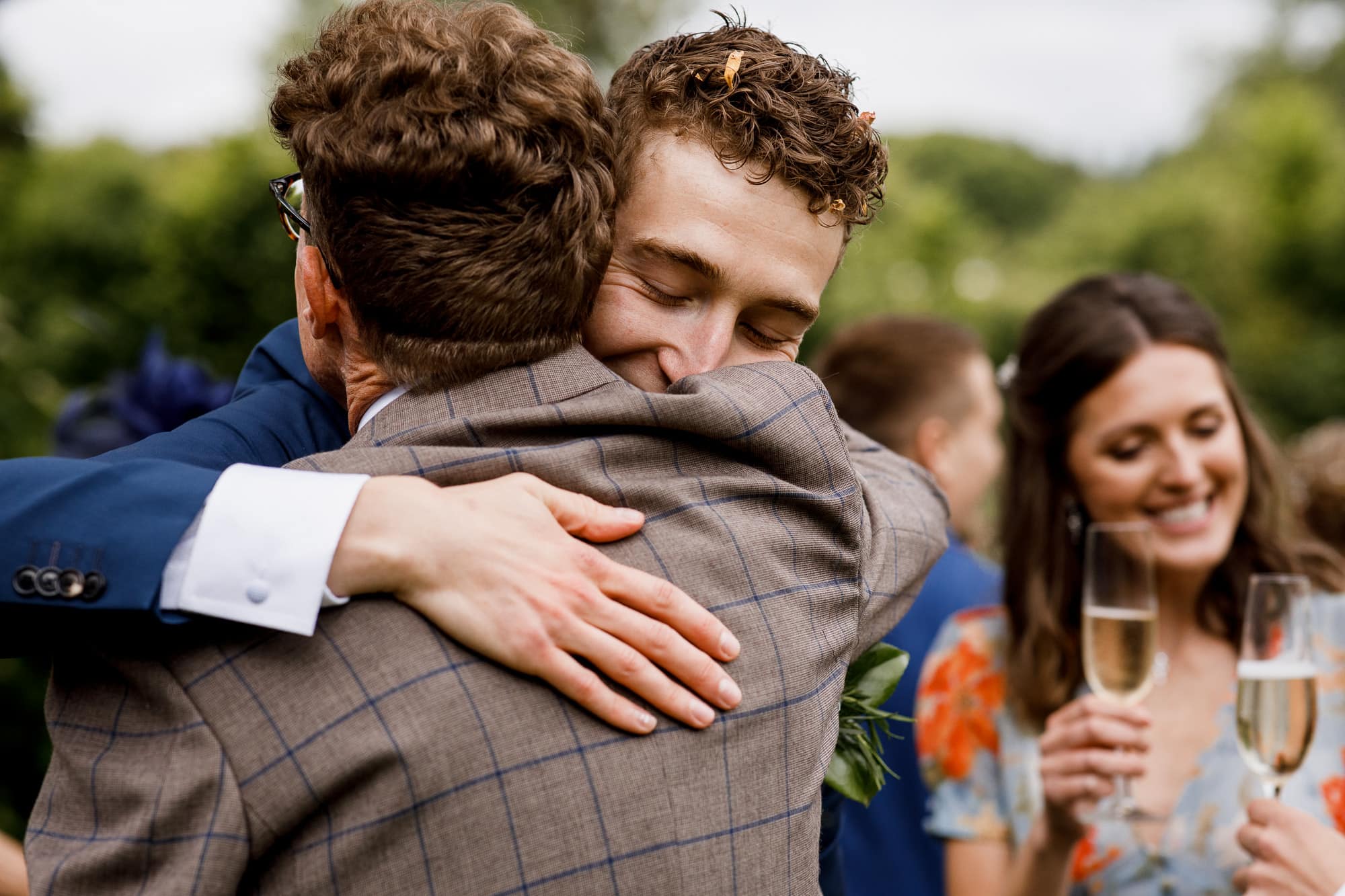 groom hugging father in law after wedding ceremony