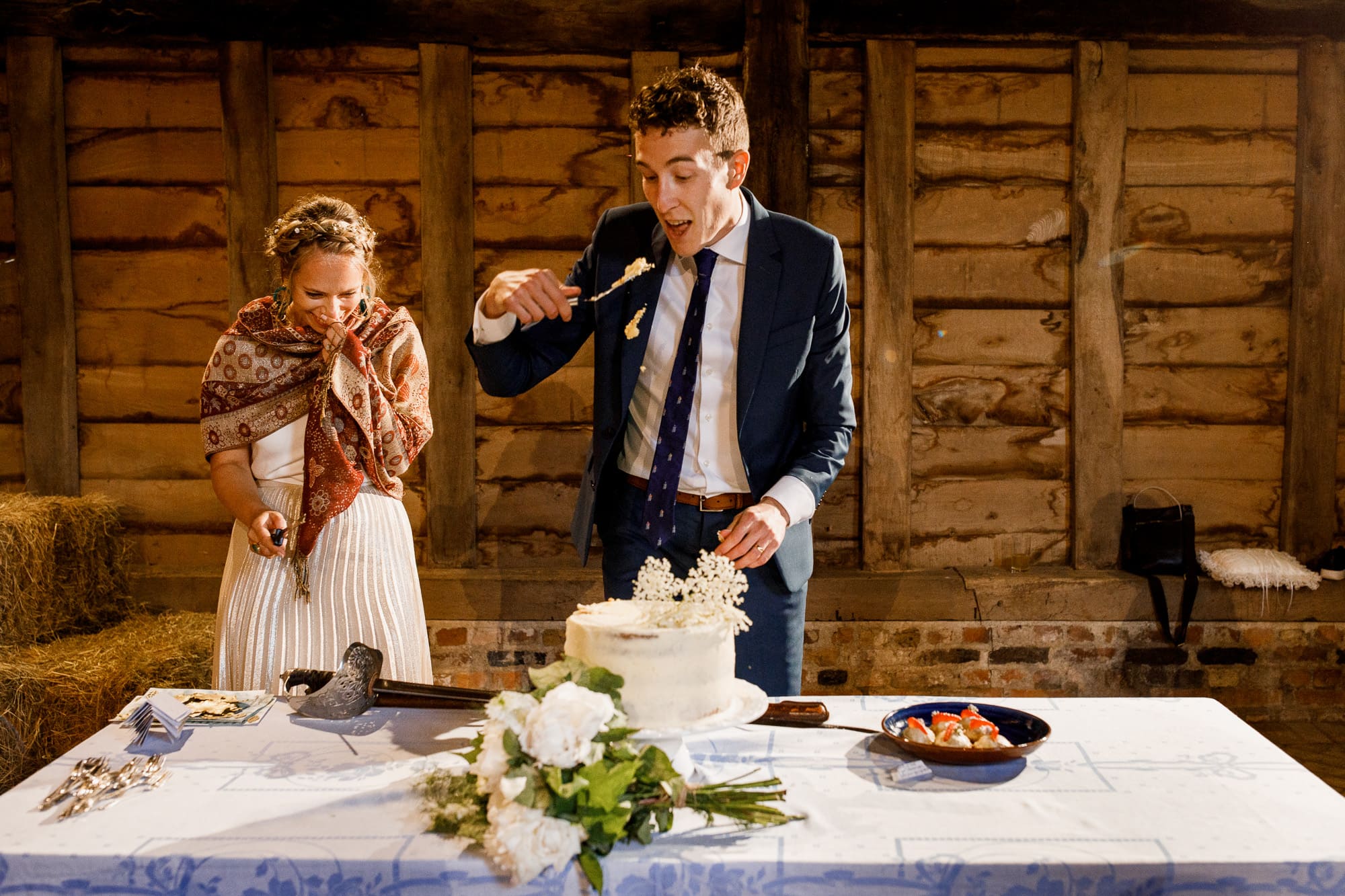 groom eating cake after cutting