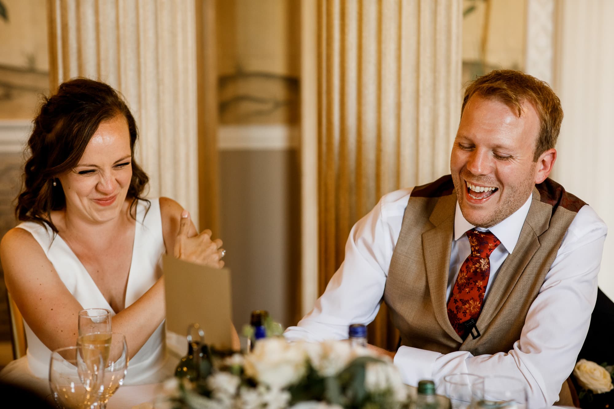 bride and groom laughing at speeches